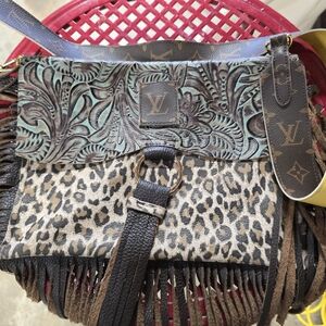 Louis vuitton accented leather cross body.